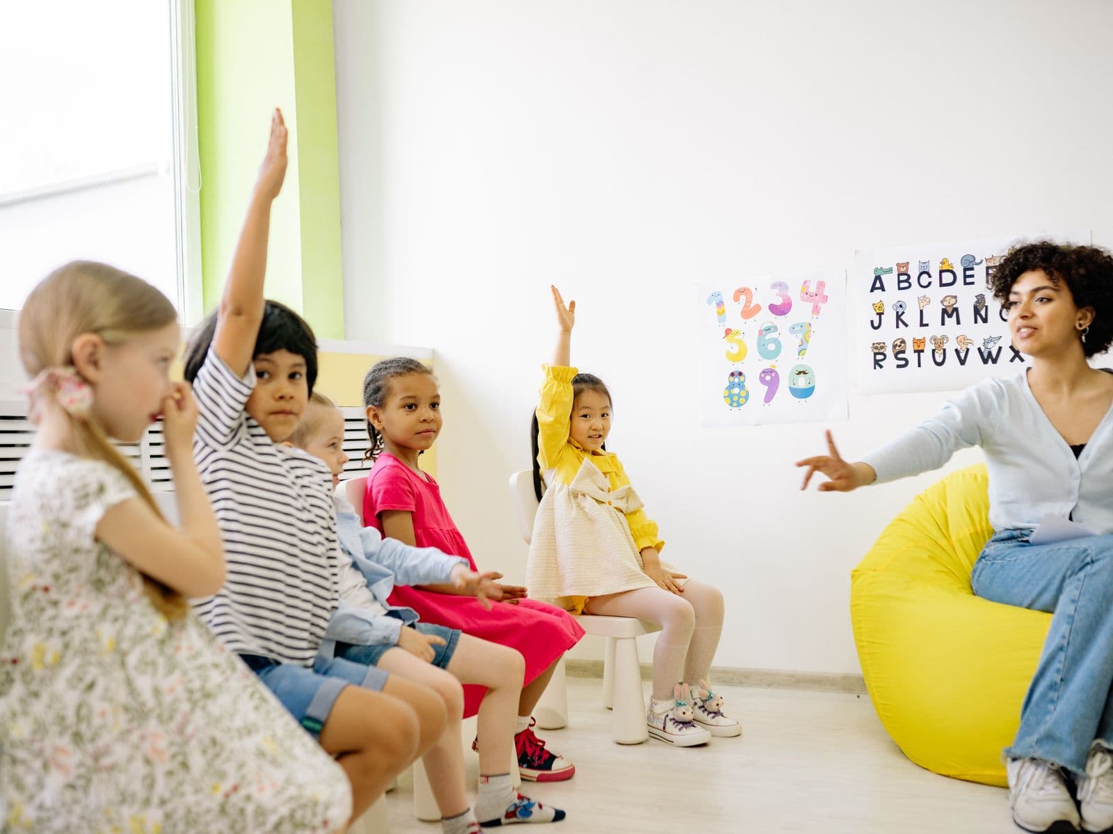 Young children engaged in a bright, modern preschool classroom